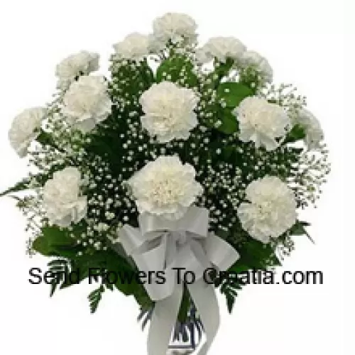 19 White Carnations With Seasonal Fillers In A Glass Vase